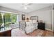 Bedroom with a metal frame bed, large window and hardwood flooring with area rug at 11505 Cerca Del Rio, Temple Terrace, FL 33617