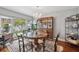 Elegant dining room with a chandelier, glass table, and ample natural light at 11505 Cerca Del Rio, Temple Terrace, FL 33617