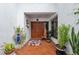 Inviting home entrance with brick flooring, double doors, and decorative plants at 11505 Cerca Del Rio, Temple Terrace, FL 33617