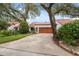 Inviting home showcasing a lush lawn, mature trees, and a neatly paved driveway at 11505 Cerca Del Rio, Temple Terrace, FL 33617