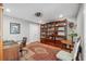 Home office features built in bookshelves, hardwood flooring and a classic desk at 11505 Cerca Del Rio, Temple Terrace, FL 33617