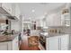 Modern kitchen featuring white cabinets, stainless steel appliances, granite countertops and hardwood flooring at 11505 Cerca Del Rio, Temple Terrace, FL 33617