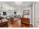 Open-concept living room with hardwood floors, fireplace, and adjacent kitchen area at 11505 Cerca Del Rio, Temple Terrace, FL 33617