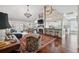 Spacious living room with a fireplace, chandelier, and open access to the kitchen at 11505 Cerca Del Rio, Temple Terrace, FL 33617