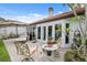 Inviting brick patio with seating area and lush landscaping, perfect for outdoor entertaining and relaxation at 11505 Cerca Del Rio, Temple Terrace, FL 33617