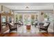 Bright sunroom with tile flooring, comfortable seating, and views of the backyard at 11505 Cerca Del Rio, Temple Terrace, FL 33617