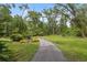 Beautiful walking path surrounded by lush greenery, perfect for leisurely strolls and enjoying nature at 11505 Cerca Del Rio, Temple Terrace, FL 33617
