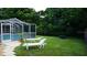 Backyard view showing lounge chairs, a fire pit, and the pool at 11810 Oceanside Dr, Port Richey, FL 34668