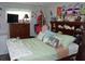 Cozy bedroom with decorative pillows, dresser, and nautical-themed decor above headboard at 11810 Oceanside Dr, Port Richey, FL 34668