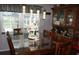 Dining room with a glass-top table and classic china cabinet at 11810 Oceanside Dr, Port Richey, FL 34668