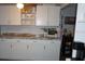 Kitchen featuring white cabinets, granite countertops, and a breakfast bar at 11810 Oceanside Dr, Port Richey, FL 34668