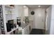 Galley kitchen with white cabinets, granite countertops, and stainless steel appliances at 11810 Oceanside Dr, Port Richey, FL 34668