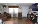 Living room featuring hard surface flooring, comfortable seating, and a large window at 11810 Oceanside Dr, Port Richey, FL 34668