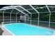 Inviting screened-in pool featuring clear, blue water and a spacious deck area perfect for relaxing at 11810 Oceanside Dr, Port Richey, FL 34668