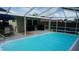 Lovely screened-in pool with an outdoor dining set and lots of space for entertaining at 11810 Oceanside Dr, Port Richey, FL 34668