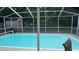 The screened-in pool area with lots of space and a view of the backyard, provides a private and enjoyable retreat at 11810 Oceanside Dr, Port Richey, FL 34668