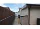 View of the exterior side yard showing the fence and a storage shed at 11810 Oceanside Dr, Port Richey, FL 34668