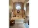 Soaking tub in a well-lit bathroom with a vaulted ceiling and decorative accents at 1231 Etta Ave, Spring Hill, FL 34609