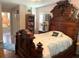 Bedroom featuring an antique-style bed frame, complemented by a view of the Primary bath at 1231 Etta Ave, Spring Hill, FL 34609