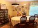 Bright dining room with decorative plates on the wall and a table set for six at 1231 Etta Ave, Spring Hill, FL 34609