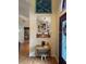 Bright entryway featuring stylish wall decor, wooden flooring, and a view towards the stainless steel kitchen appliances at 1231 Etta Ave, Spring Hill, FL 34609