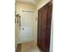 Clean hallway view showcasing a white door, a large brown cabinet, and a neutral rug at 1231 Etta Ave, Spring Hill, FL 34609