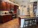 Spacious kitchen boasts custom wood cabinetry, stainless steel appliances, tile backsplash, and a granite-topped island with seating at 1231 Etta Ave, Spring Hill, FL 34609