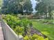 Landscaped backyard with manicured lawn, flowerbeds, and mature trees at 1231 Etta Ave, Spring Hill, FL 34609