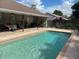 Swimming pool with patio, covered outdoor dining and fenced backyard at 1231 Etta Ave, Spring Hill, FL 34609