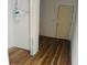 Unfinished bedroom featuring wood-look flooring and a white door at 14586 Mocking Wren Rd, Weeki Wachee, FL 34614