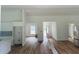 Open-concept space with wood-look floors and bright natural light, flowing through the house at 14586 Mocking Wren Rd, Weeki Wachee, FL 34614