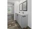 Modern bathroom featuring a double vanity with a gray cabinet and black hardware at 16104 Naples St, Brooksville, FL 34604