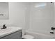 This is a bathroom with white tile at 16104 Naples St, Brooksville, FL 34604