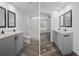 Bathroom featuring dual sinks, gray vanity, framed mirrors, and a bright walk-in shower at 16104 Naples St, Brooksville, FL 34604