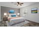 Comfortable bedroom with neutral colors, a ceiling fan, and stylish artwork, creating a peaceful retreat at 16104 Naples St, Brooksville, FL 34604