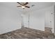 Bright bedroom features wood-look flooring, white trim, and ceiling fan at 16104 Naples St, Brooksville, FL 34604