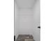 Walk-in closet features white walls, wire shelving, and wood-look flooring at 16104 Naples St, Brooksville, FL 34604