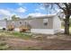 Exterior of home showing the side yard, siding, windows, and wooden stairs at 16104 Naples St, Brooksville, FL 34604
