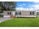 Charming single-story home with a well-maintained lawn, inviting entryway, and pleasing landscaping at 16104 Naples St, Brooksville, FL 34604