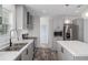 Bright kitchen features stainless appliances, white counters, a center island, and gray cabinetry at 16104 Naples St, Brooksville, FL 34604