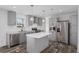 Bright kitchen features stainless appliances, white counters, a center island, and gray cabinetry at 16104 Naples St, Brooksville, FL 34604
