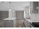 Bright kitchen features a center island, white counters, stainless appliances, and gray cabinets at 16104 Naples St, Brooksville, FL 34604