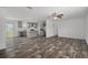 Expansive living room featuring modern flooring and an open layout seamlessly connecting to the stylish kitchen at 16104 Naples St, Brooksville, FL 34604