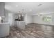 Inviting living area flowing into an open kitchen layout, complete with modern appliances and sleek flooring at 16104 Naples St, Brooksville, FL 34604
