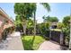 Well-maintained yard with stone pathway, greenery, and secure fencing at 1831 Cardamon Dr, Trinity, FL 34655