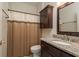 Bathroom with granite countertops, dark wood cabinetry, and a shower with patterned curtains at 1831 Cardamon Dr, Trinity, FL 34655