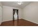 Bedroom with wood floors, a ceiling fan, and a window with patterned curtains at 1831 Cardamon Dr, Trinity, FL 34655