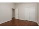 Bedroom has wood floors and double closets with open door to another room at 1831 Cardamon Dr, Trinity, FL 34655