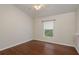 Neutral bedroom with hardwood floors, a ceiling fan, and a window for natural light at 1831 Cardamon Dr, Trinity, FL 34655