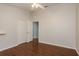 Light and airy bedroom has hardwood floors and a double closet with white doors at 1831 Cardamon Dr, Trinity, FL 34655